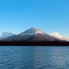 a large body of water with a mountain in the background